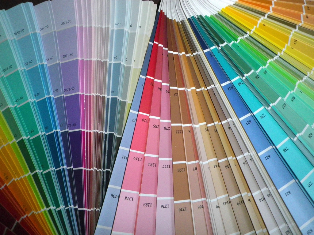 Rows of colour swatches fanned out on a designer's desk