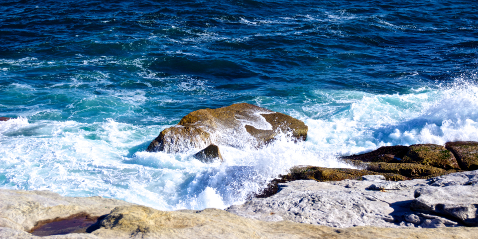 Ocean waves breaking against a rocky shoreline