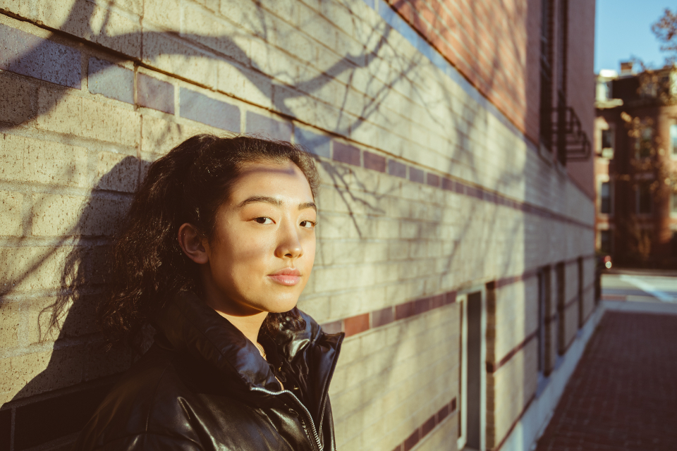 Sunlight through a window casting striped shadows across a face