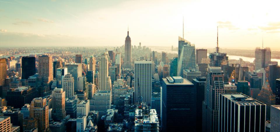 A city skyline seen from a rooftop at dusk