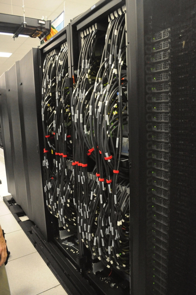 Rows of illuminated server racks inside a data center aisle