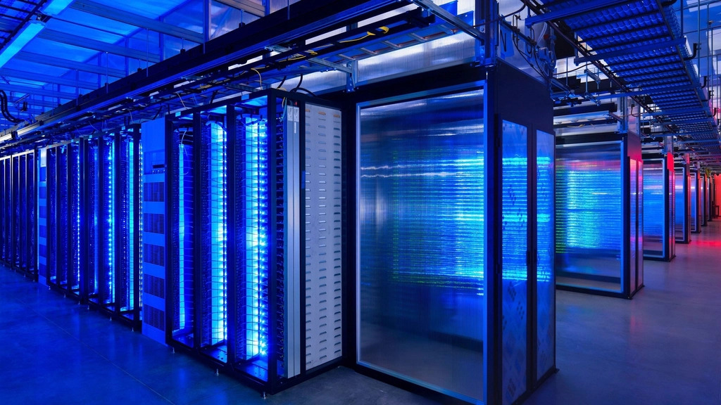 Rows of servers in a dimly lit data centre aisle