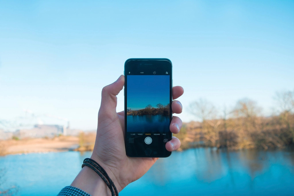 Someone holding a phone at arm's length to take a selfie