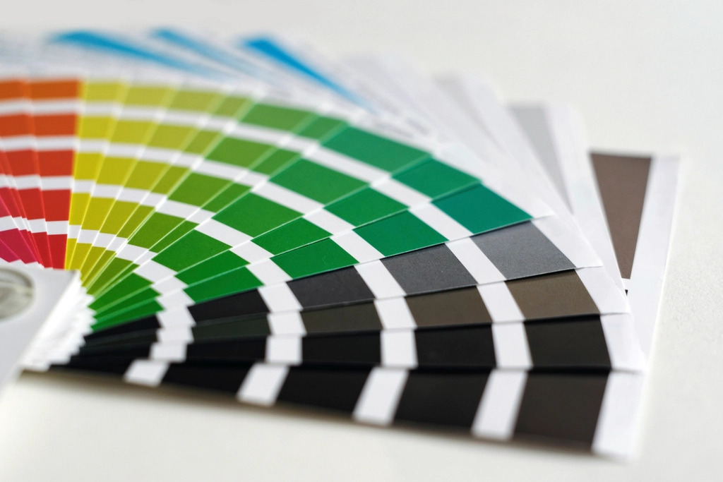 Fanned-out paint swatch cards showing a graded range of colours