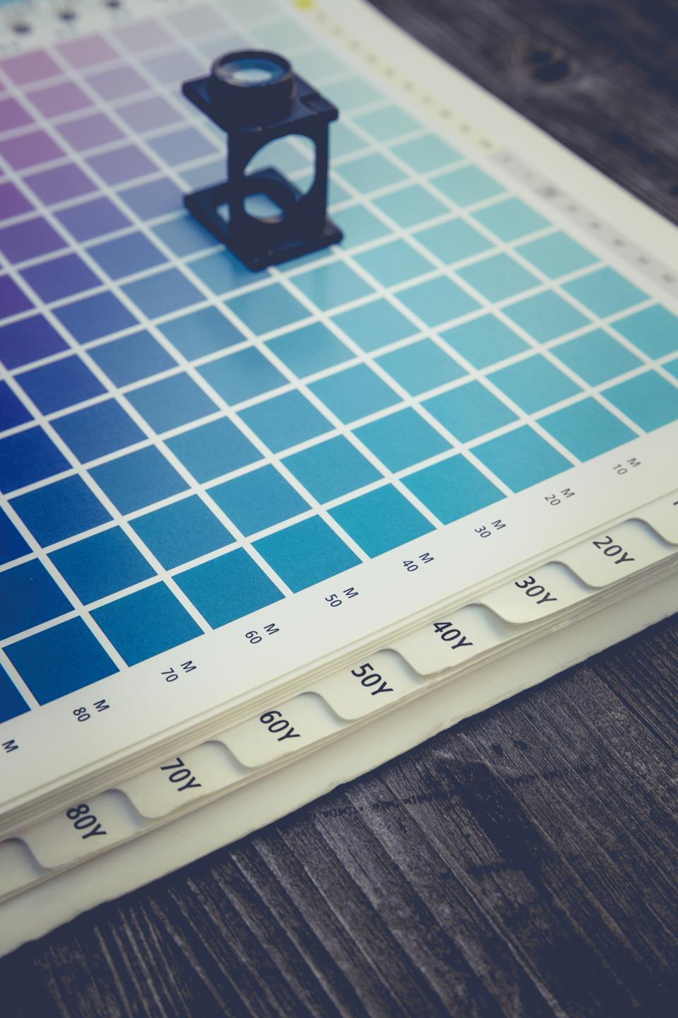 Rows of colorful paint swatches laid out on paper