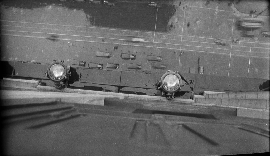 Overhead aerial view of a city street with cars and pedestrians